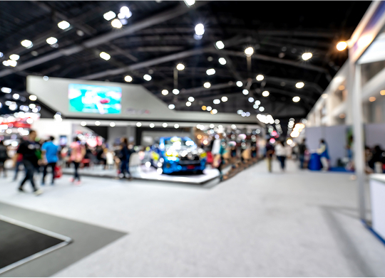 Blurry image capturing a crowd of people engaged in an event, conveying a sense of activity and excitement.