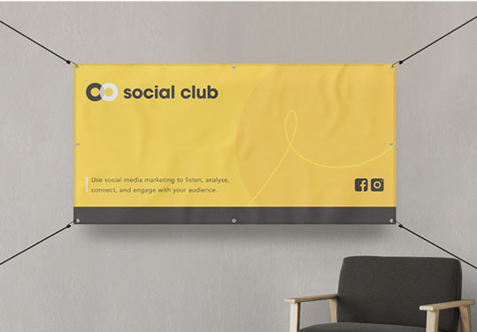 A yellow banner displayed on a wall above a chair, creating a vibrant and inviting atmosphere in the room.