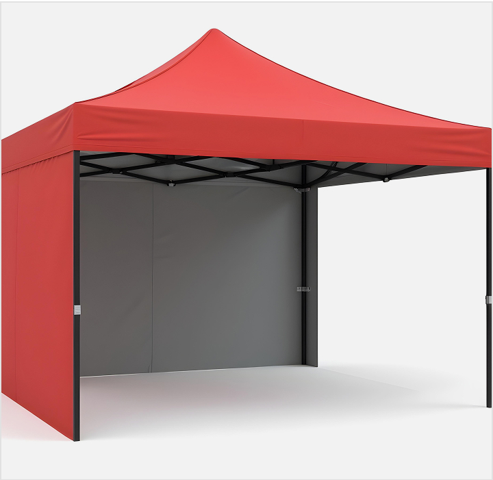 A red tent with a black frame and a white wall set up outdoors, showcasing its vibrant color and structure.