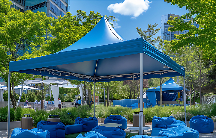 A blue canopy shelters colorful bean bags and chairs arranged for relaxation in an outdoor setting.