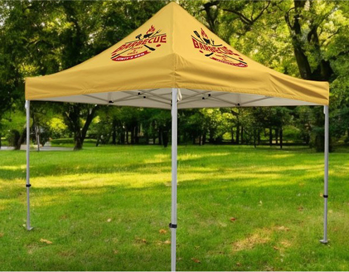 A yellow canopy tent featuring a prominent logo displayed on its side.